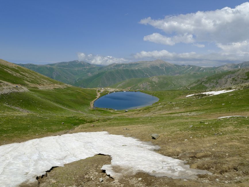 Breathtaking view of a serene lake surrounded by lush green mountains in Demirkapı, Trabzon.