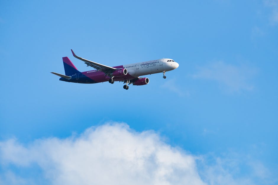 A Wizz Air airplane flying against a clear blue sky over Slovakia.