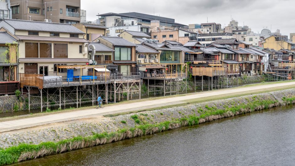Scenic view of traditional Japanese architecture along the Kamo River in Kyoto.