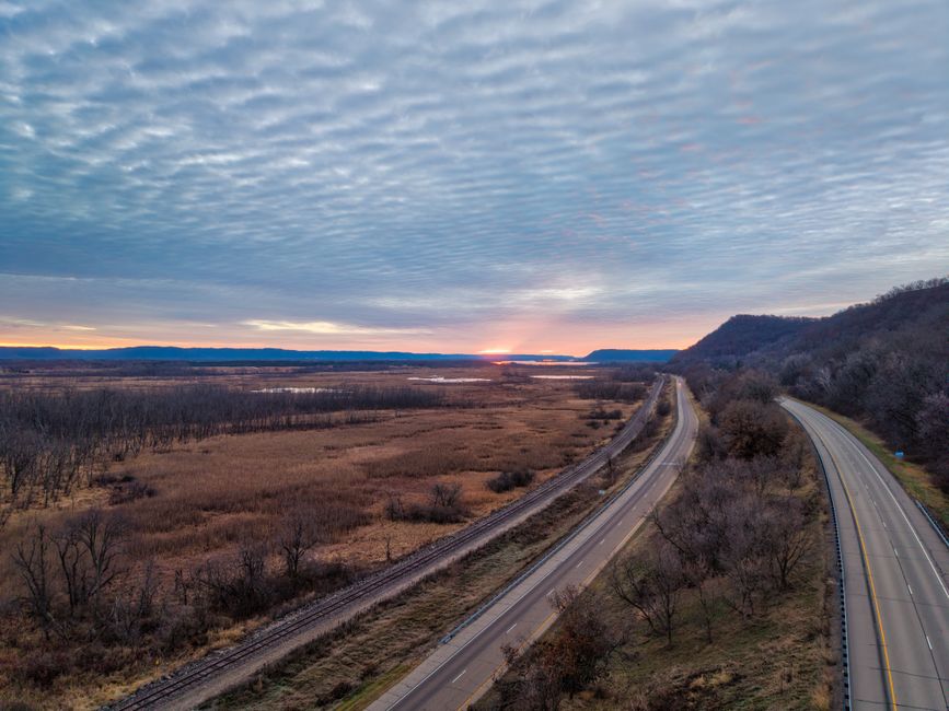 Aerial view of a scenic highway and landscape in Weaver, Minnesota at sunset.