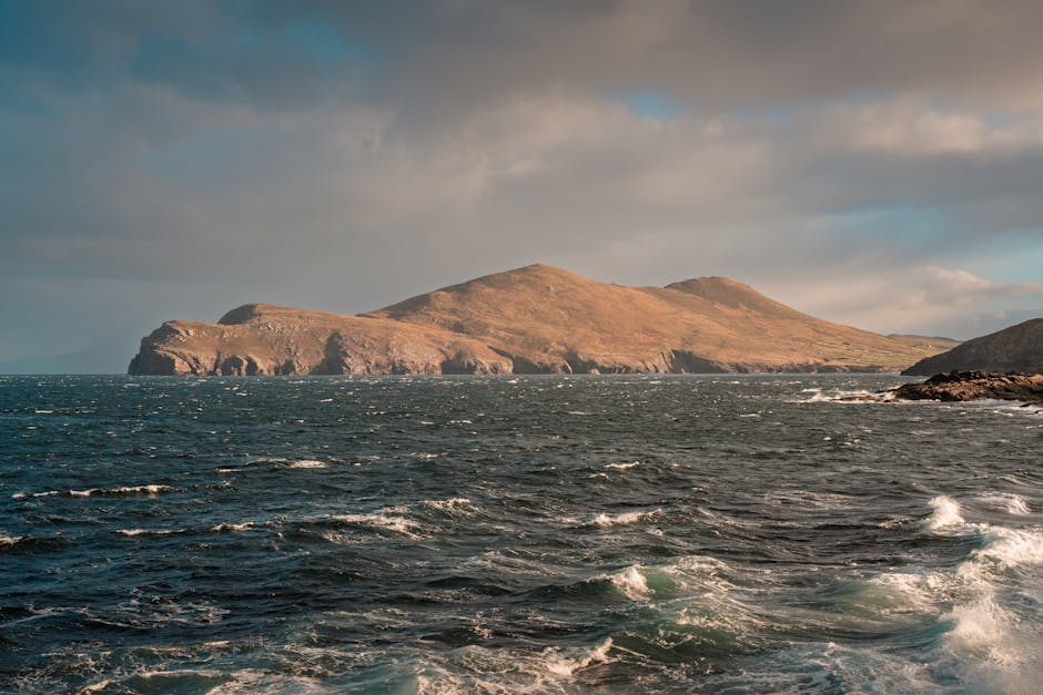 Explore the rugged beauty of Ireland's coastal cliffs under dramatic skies and choppy seas.